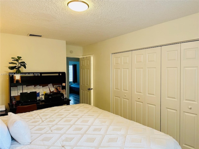 bedroom with a closet and a textured ceiling