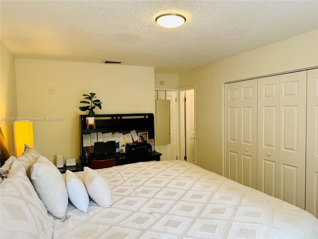 bedroom with a closet and a textured ceiling