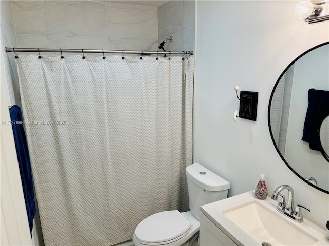 bathroom featuring vanity, toilet, and walk in shower