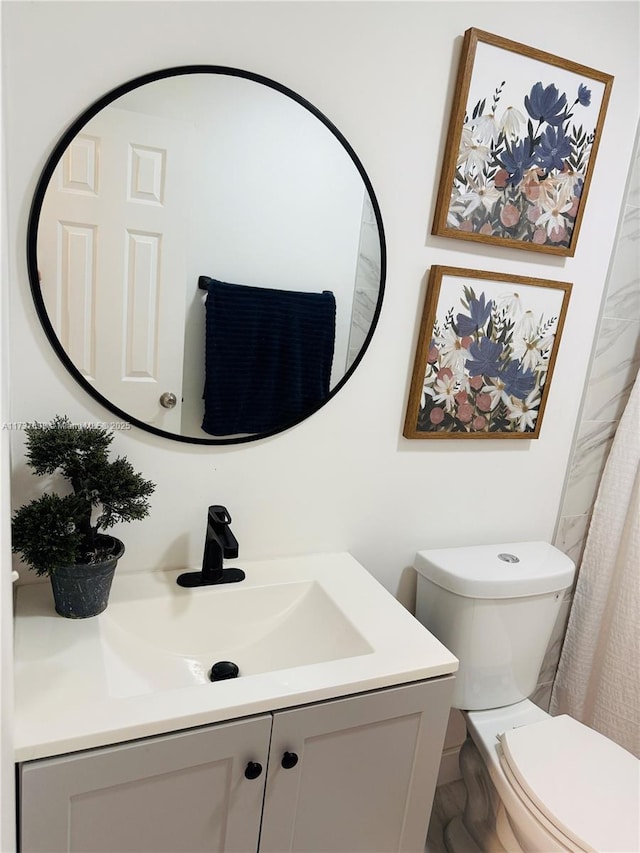 bathroom featuring vanity and toilet