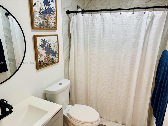 bathroom featuring walk in shower, vanity, and toilet