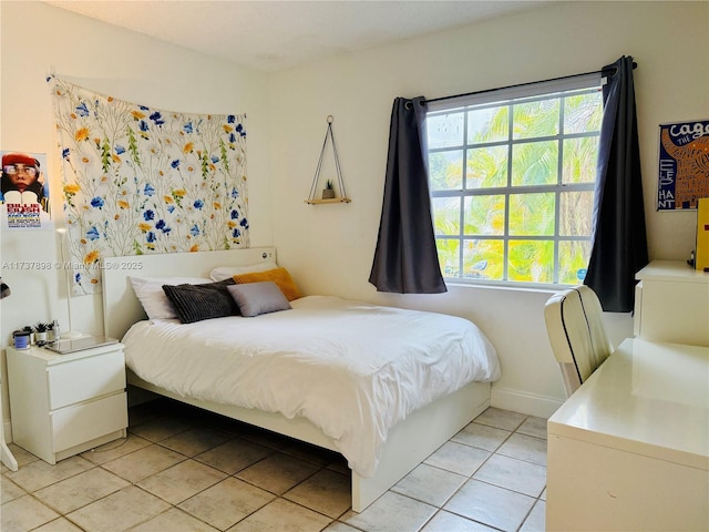 tiled bedroom featuring multiple windows