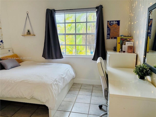 bedroom with light tile patterned floors