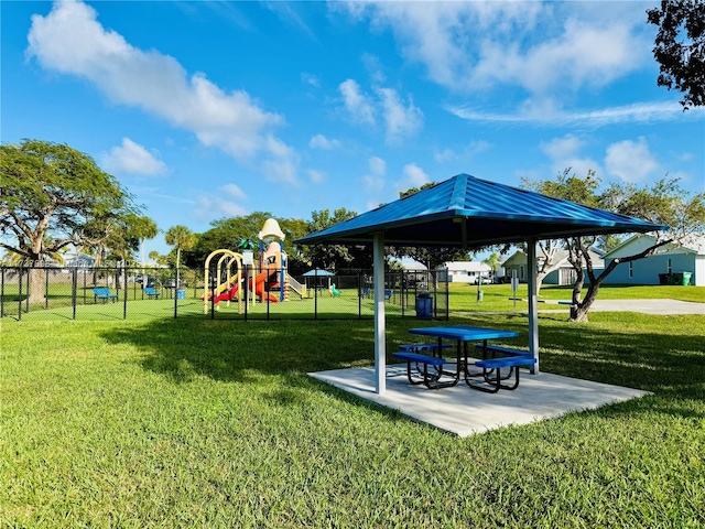 view of home's community featuring a yard and a playground