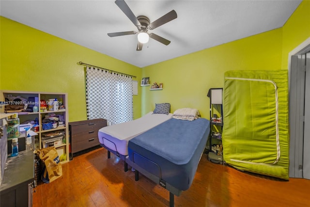 bedroom with hardwood / wood-style flooring and ceiling fan