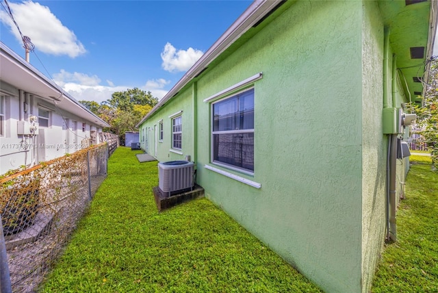 view of home's exterior featuring a lawn and central air condition unit