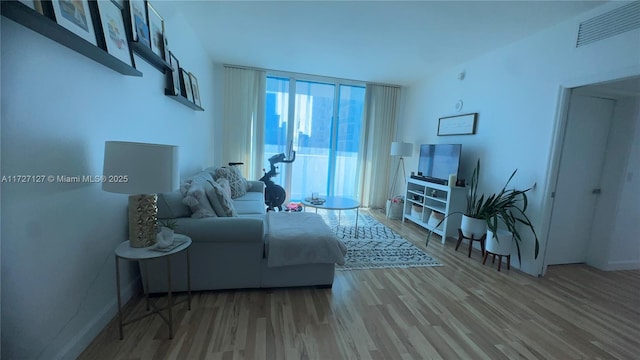 living room featuring floor to ceiling windows and hardwood / wood-style floors