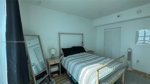 bedroom featuring light hardwood / wood-style floors and a closet