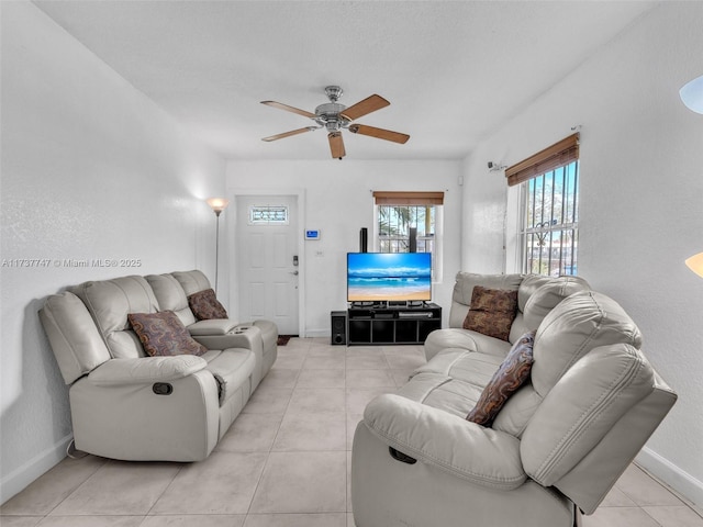 living room featuring ceiling fan and light tile patterned floors