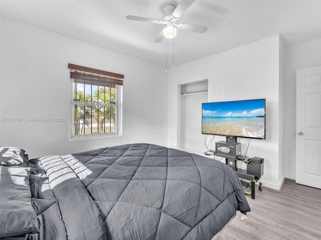 bedroom with hardwood / wood-style floors and ceiling fan