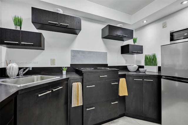 kitchen featuring stainless steel refrigerator and sink