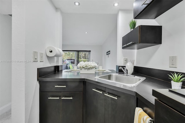 kitchen featuring lofted ceiling and sink