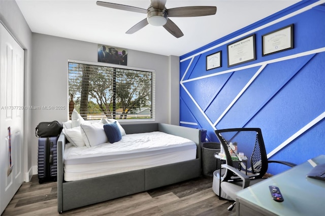 bedroom with hardwood / wood-style flooring and ceiling fan