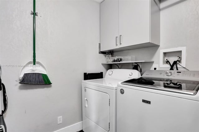 laundry room featuring washing machine and dryer and cabinets