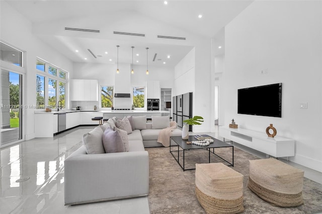 living room with sink and a high ceiling