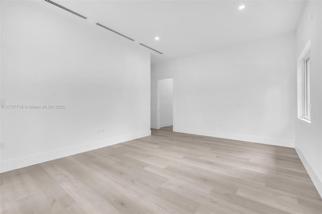 spare room featuring light hardwood / wood-style flooring