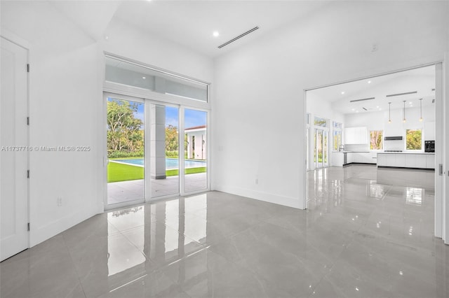 empty room featuring a towering ceiling