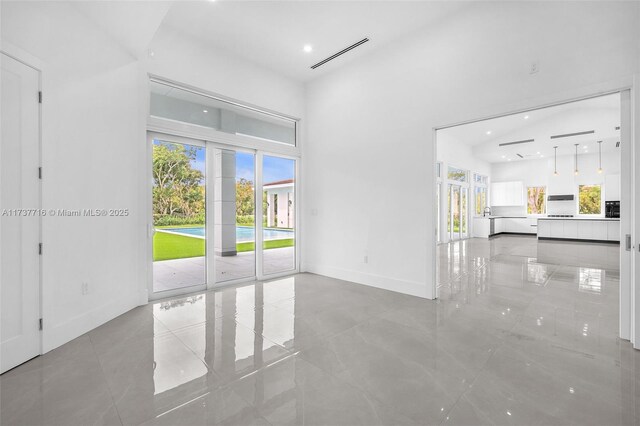 kitchen with stainless steel appliances, white cabinetry, a center island, and pendant lighting