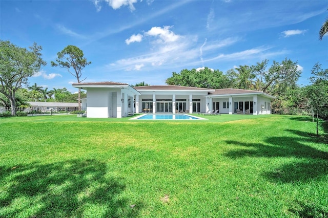 back of property featuring a lawn