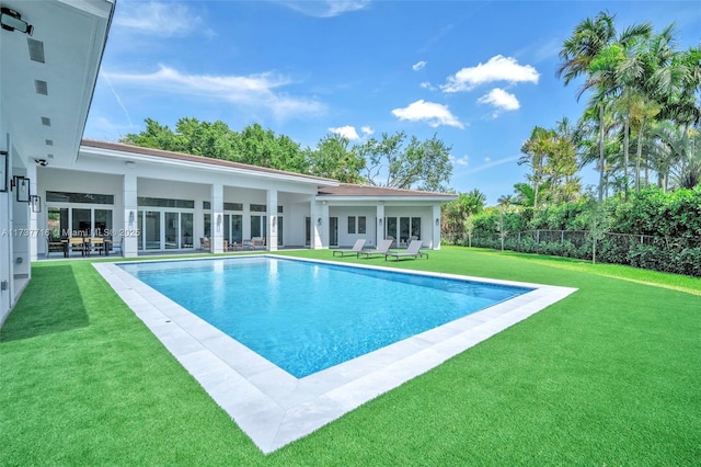 view of pool featuring a lawn