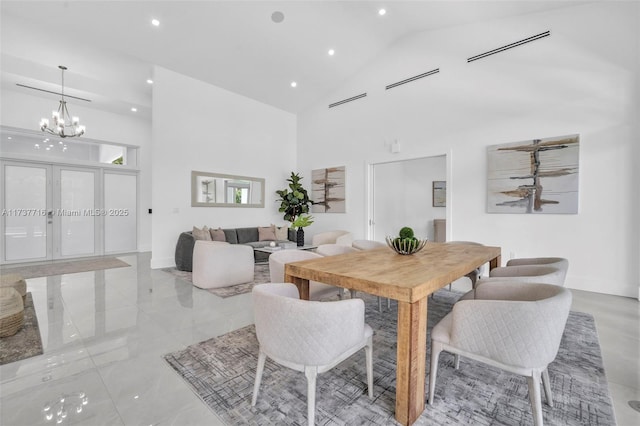 dining space with french doors, an inviting chandelier, and high vaulted ceiling