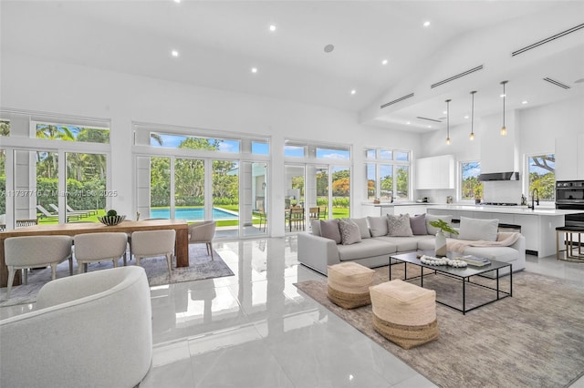 interior space featuring plenty of natural light, high vaulted ceiling, and french doors