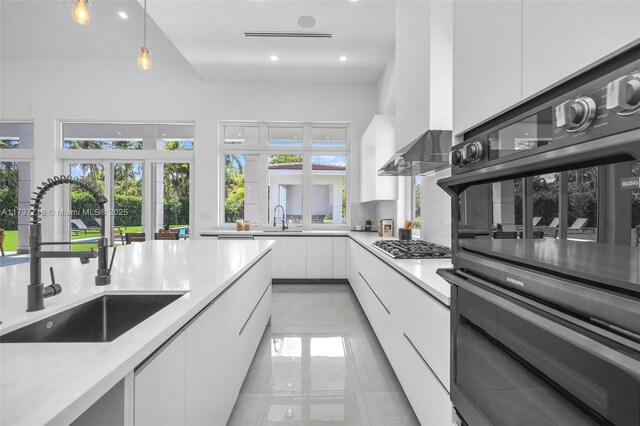 kitchen with white cabinetry and sink