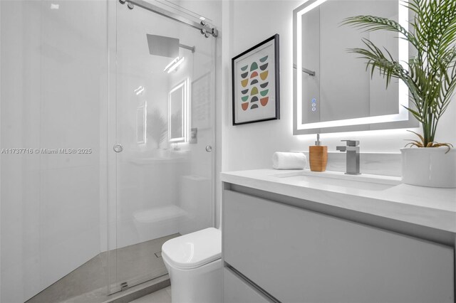 bathroom featuring vanity, walk in shower, and toilet