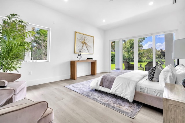 bedroom with access to exterior and light wood-type flooring