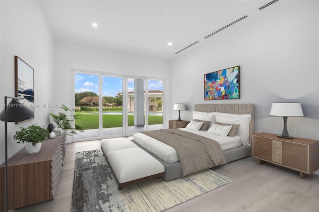 bedroom featuring light hardwood / wood-style floors and access to outside