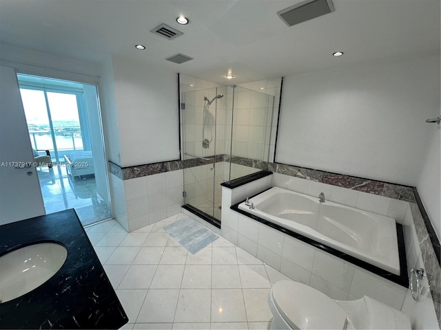 full bathroom with vanity, tile patterned floors, independent shower and bath, and toilet