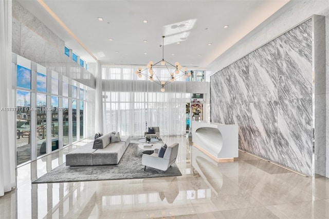 interior space with expansive windows, a healthy amount of sunlight, and a notable chandelier