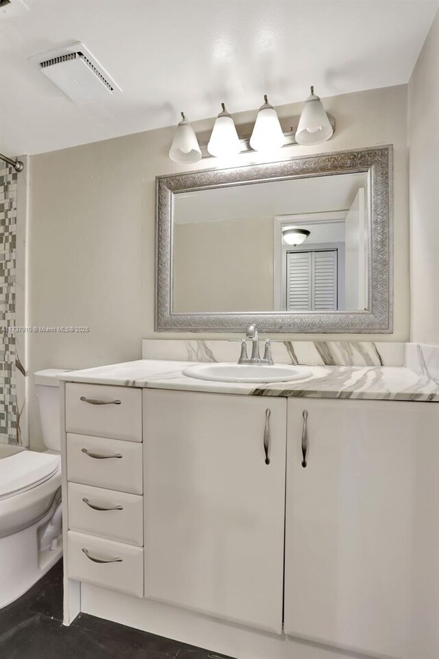 bathroom featuring vanity and toilet