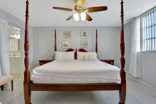 bedroom with ceiling fan, ensuite bath, and light tile patterned flooring