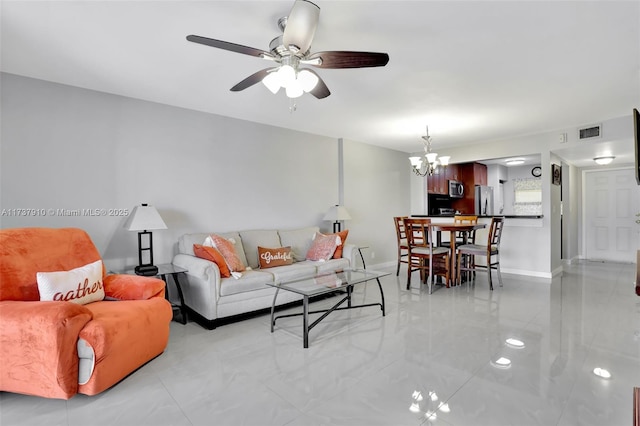 living room featuring ceiling fan with notable chandelier