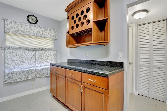 kitchen featuring dark stone countertops and light tile patterned floors