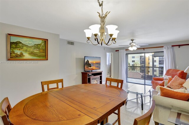 dining room featuring ceiling fan with notable chandelier