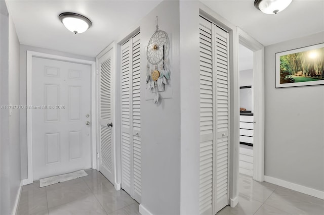 hall featuring light tile patterned floors