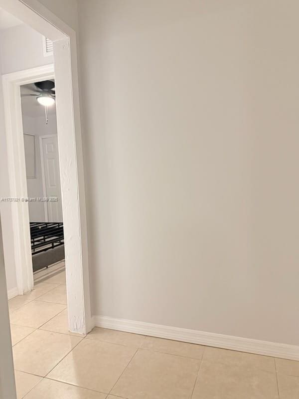 corridor featuring light tile patterned flooring