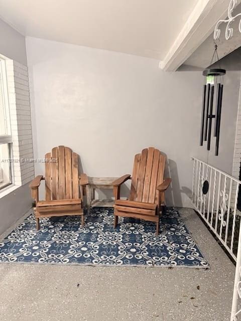 sitting room featuring beam ceiling