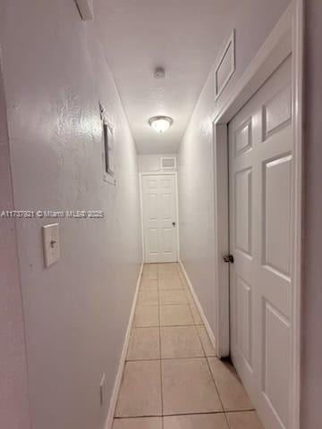 hallway featuring light tile patterned floors