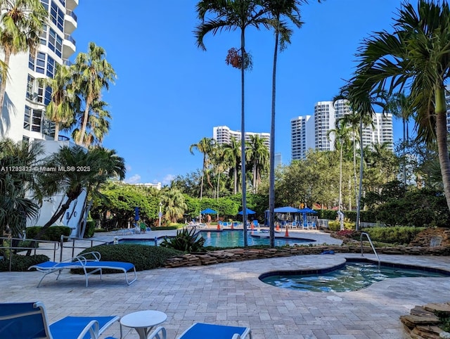 view of home's community featuring a swimming pool and a patio