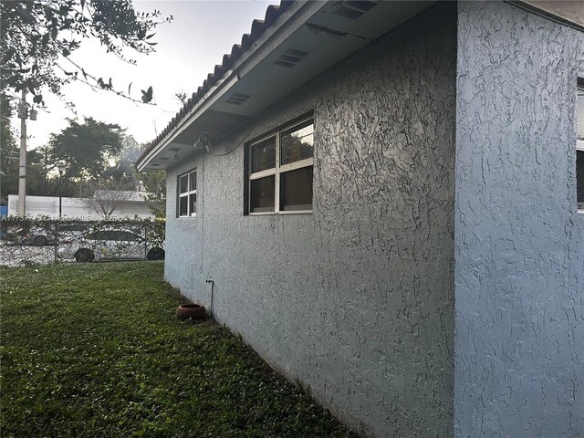 view of property exterior featuring a yard