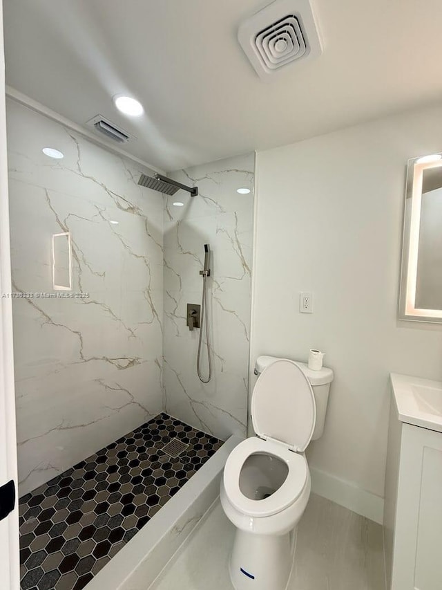 bathroom with toilet, a marble finish shower, vanity, and visible vents