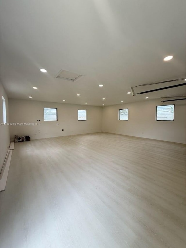 below grade area featuring light wood-type flooring and recessed lighting