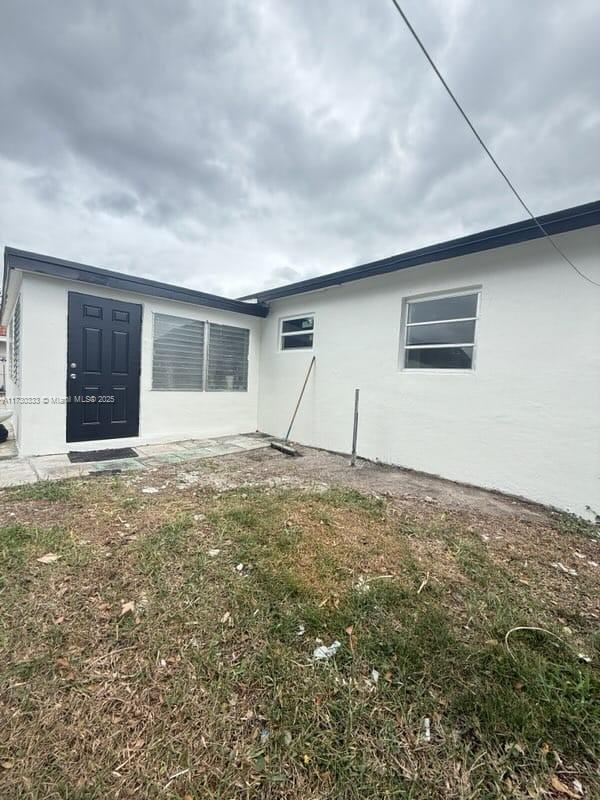 back of house with stucco siding