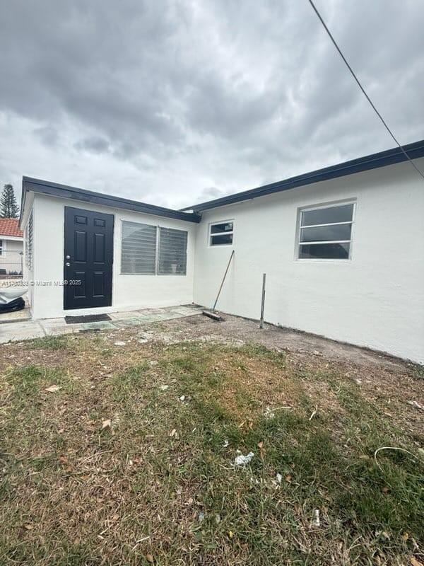 rear view of property with stucco siding