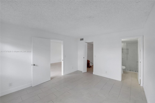 spare room with a textured ceiling