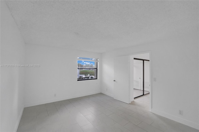 spare room with a textured ceiling