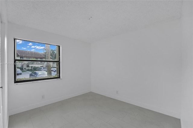 spare room with a textured ceiling